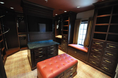 Mid-sized elegant gender-neutral carpeted dressing room photo in Dallas with recessed-panel cabinets and dark wood cabinets