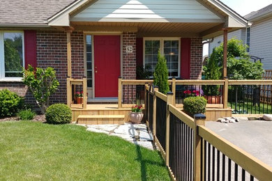 Inspiration for a small modern deck remodel in Toronto with a roof extension