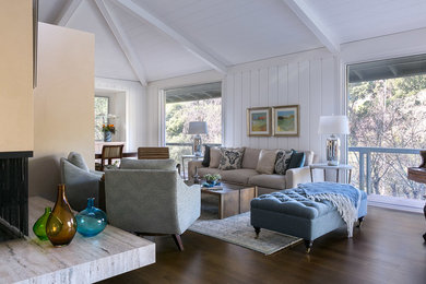 Example of a mid-sized mid-century modern enclosed dark wood floor and brown floor family room design in San Francisco with white walls