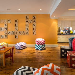 Traditional walk-out basement in San Francisco with medium hardwood flooring, no fireplace and orange walls.