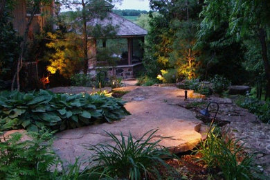 Example of a mid-sized classic backyard stone patio design in Toronto with a gazebo