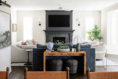 Example of a mid-sized classic open concept medium tone wood floor living room design in Denver with white walls, a standard fireplace, a tile fireplace and a wall-mounted tv