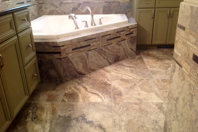 This is an example of a mid-sized transitional bathroom in Other with a corner tub, brown tile, porcelain tile and porcelain floors.