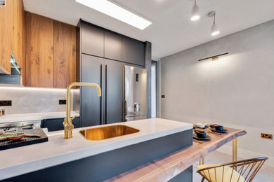 Design ideas for a medium sized modern grey and black u-shaped kitchen/diner in London with flat-panel cabinets, tile countertops, grey splashback, porcelain splashback, stainless steel appliances, porcelain flooring, a breakfast bar, grey floors, white worktops, an integrated sink, black cabinets and feature lighting.