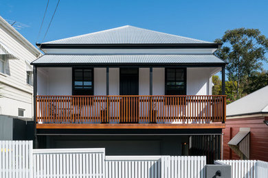 Design ideas for a contemporary two-storey white house exterior in Brisbane with mixed siding, a hip roof and a metal roof.
