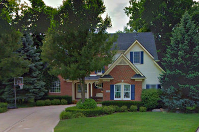 Mid-sized transitional multicolored two-story mixed siding exterior home idea in St Louis with a shingle roof