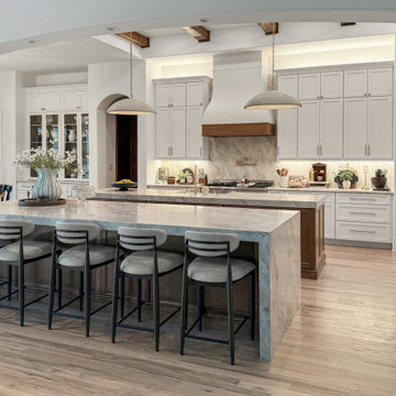 Gourmet Range Wall with Flared Plaster Hood, Taj Mahal Quartzite Slab, and Integ