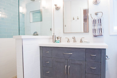 Inspiration for a transitional master blue tile, white tile and subway tile pebble tile floor alcove shower remodel in San Francisco with beaded inset cabinets and gray cabinets