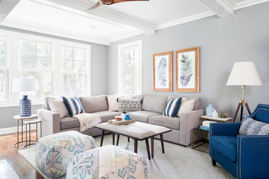 Transitional open concept medium tone wood floor living room photo in New York with gray walls