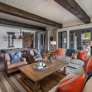 Design ideas for a beach style walk-out basement in Atlanta with white walls and dark hardwood flooring.