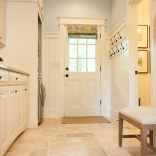 Large rural single-wall utility room in Atlanta with a submerged sink, raised-panel cabinets, distressed cabinets, granite worktops, travertine flooring, a concealed washer and dryer and beige walls.