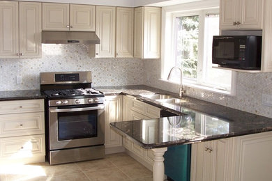 Photo of a medium sized u-shaped kitchen in Toronto with granite worktops, a submerged sink, white cabinets, stainless steel appliances, a breakfast bar, mosaic tiled splashback and porcelain flooring.