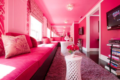 Design ideas for a living room in Denver with pink walls, dark hardwood floors, no fireplace and a wall-mounted tv.