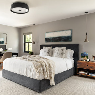 Mid-sized trendy master light wood floor and brown floor bedroom photo in New York with gray walls