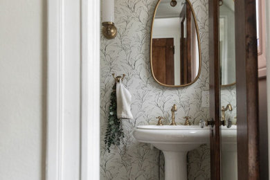 Powder room - small transitional mosaic tile floor, gray floor and wallpaper powder room idea in New York with a two-piece toilet, beige walls and a pedestal sink