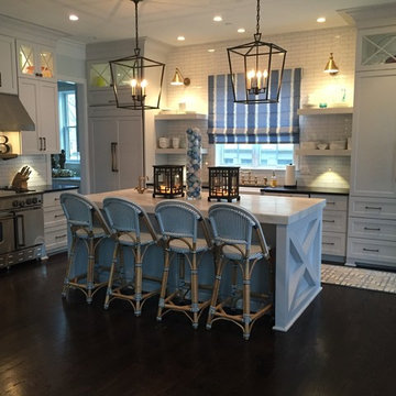 A Modern Farmhouse Kitchen with French Touches featuring a 48" BlueStar Range