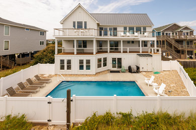 Pool - coastal backyard rectangular pool idea in Other