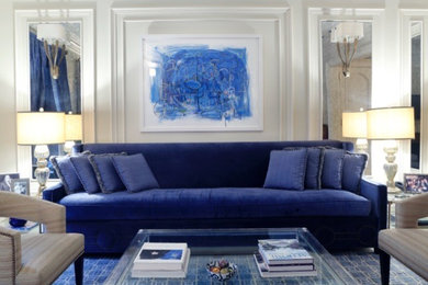Example of a mid-sized transitional formal and open concept light wood floor living room design in New York with white walls, a standard fireplace, a wood fireplace surround and no tv