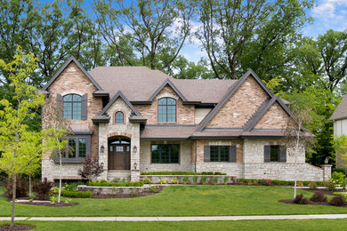This is an example of a mid-sized traditional two-storey brick house exterior in Chicago.