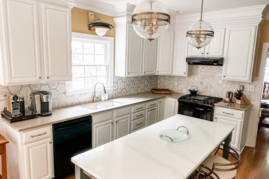 Mid-sized elegant u-shaped medium tone wood floor and brown floor eat-in kitchen photo in Other with an undermount sink, white cabinets, quartzite countertops, metallic backsplash, marble backsplash, black appliances, an island and raised-panel cabinets