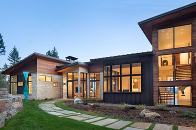 Inspiration for a huge modern brown two-story wood exterior home remodel in Other with a metal roof