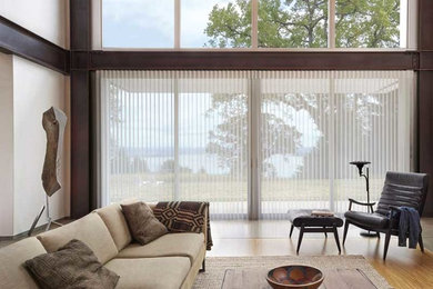 Family room - eclectic light wood floor and white floor family room idea in Vancouver with beige walls