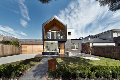 This is an example of a large modern two-storey black exterior in Melbourne with metal siding.
