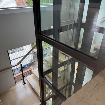 Project #136 | Modern Floating Staircase Encircling Glass Elevator
