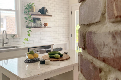 Enclosed kitchen - mid-sized transitional enclosed kitchen idea in New York with recessed-panel cabinets, white cabinets, quartz countertops, white backsplash, an island and white countertops