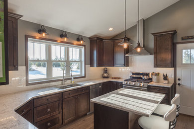 Inspiration for a large rustic u-shaped dark wood floor and brown floor enclosed kitchen remodel in Minneapolis with a double-bowl sink, shaker cabinets, dark wood cabinets, granite countertops, white backsplash, subway tile backsplash, stainless steel appliances and an island
