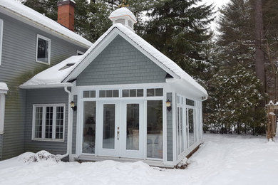 Sunroom - mid-sized traditional light wood floor and gray floor sunroom idea in Montreal with a standard fireplace