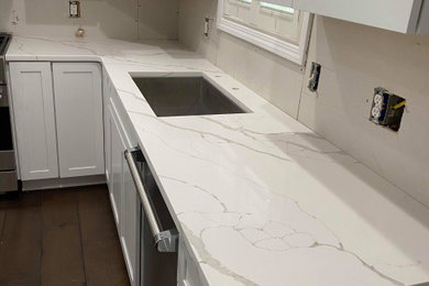 Example of a kitchen design in Louisville with marble countertops and white countertops