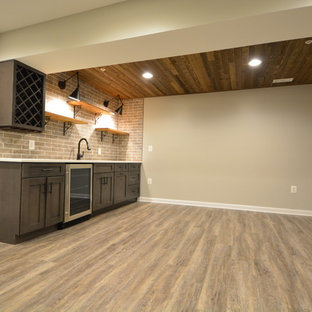Large traditional walk-out basement in Baltimore with beige walls, vinyl flooring, no fireplace and brown floors.