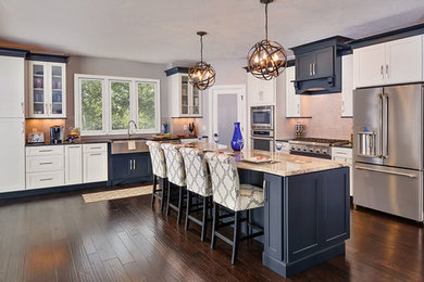 This is an example of a large transitional l-shaped eat-in kitchen in Atlanta with a farmhouse sink, shaker cabinets, white cabinets, granite benchtops, grey splashback, stone tile splashback, stainless steel appliances, dark hardwood floors and with island.