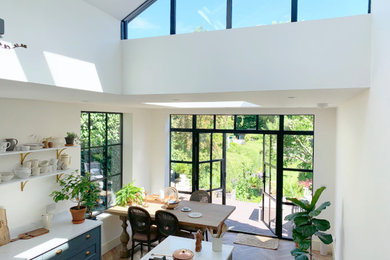 Photo of a medium sized contemporary l-shaped kitchen/diner in West Midlands with an island.