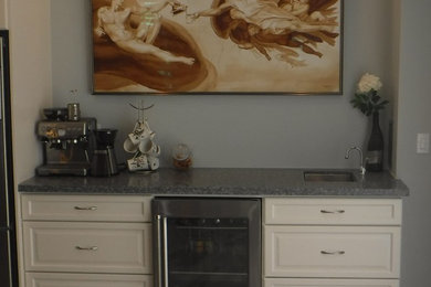 Inspiration for a large modern galley porcelain tile and gray floor home bar remodel in Toronto with raised-panel cabinets, white cabinets and quartz countertops