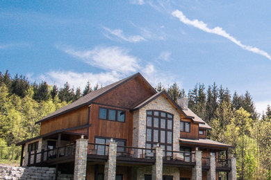 Mountain style brown three-story mixed siding exterior home photo in New York with a shingle roof