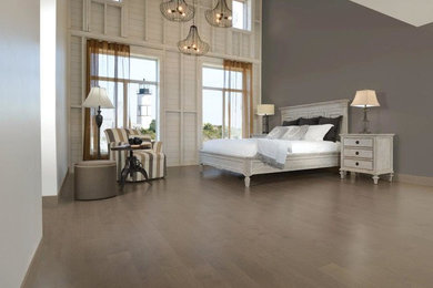 Country medium tone wood floor bedroom photo in Other with gray walls
