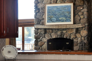 Living room - large rustic open concept medium tone wood floor living room idea in Portland Maine with green walls, a standard fireplace, a stone fireplace and a concealed tv