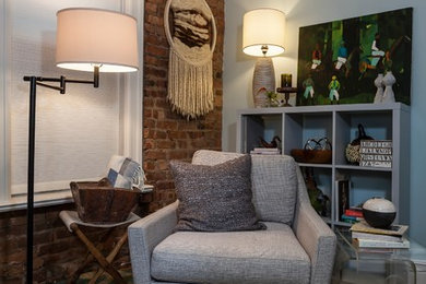 Example of a large mountain style guest light wood floor bedroom design in New York with blue walls and no fireplace