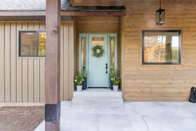 Inspiration for a large transitional green two-story wood house exterior remodel in Salt Lake City