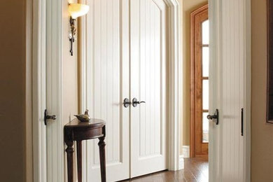 Large elegant dark wood floor hallway photo in Los Angeles with beige walls