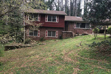 Huge mid-century modern beige two-story mixed siding exterior home photo in Atlanta with a shingle roof