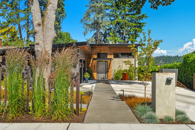 Large industrial gray two-story mixed siding house exterior idea in Seattle with a shed roof, a metal roof and a gray roof