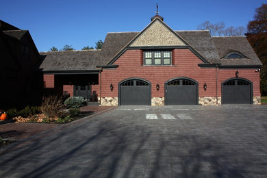 Example of a transitional red gable roof design in Boston
