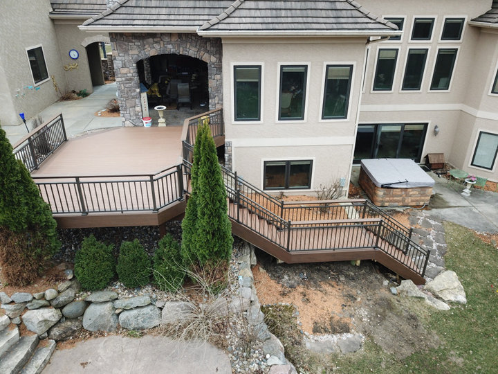 Mid-sized backyard ground level metal railing deck photo with no cover