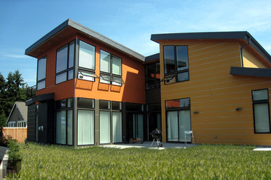 Photo of a contemporary two-storey multi-coloured exterior in Seattle with mixed siding.
