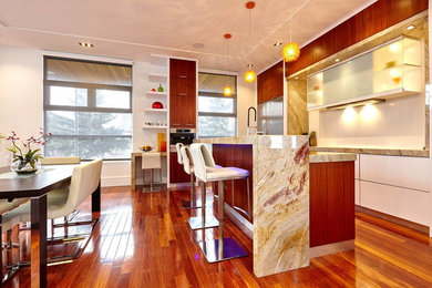 Inspiration for a large modern u-shaped medium tone wood floor open concept kitchen remodel in Toronto with a double-bowl sink, flat-panel cabinets, medium tone wood cabinets, granite countertops, stone slab backsplash, stainless steel appliances and an island