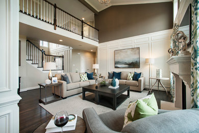 Photo of a large transitional open concept living room in Philadelphia with brown walls, a standard fireplace, a wall-mounted tv and dark hardwood floors.