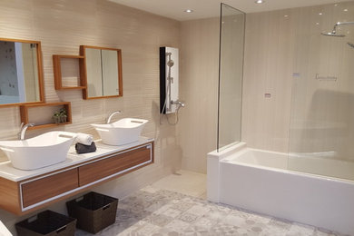 Design ideas for a large contemporary master bathroom in Toronto with flat-panel cabinets, light wood cabinets, a drop-in tub, multi-coloured tile, porcelain tile, multi-coloured walls, porcelain floors, a drop-in sink, quartzite benchtops, grey floor and an open shower.